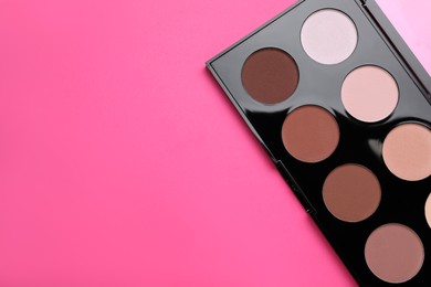 Photo of Colorful contouring palette on pink background, top view with space for text. Professional cosmetic product