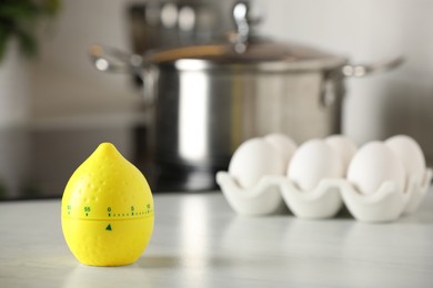 Photo of Kitchen timer in shape of lemon on white table indoors. Space for text