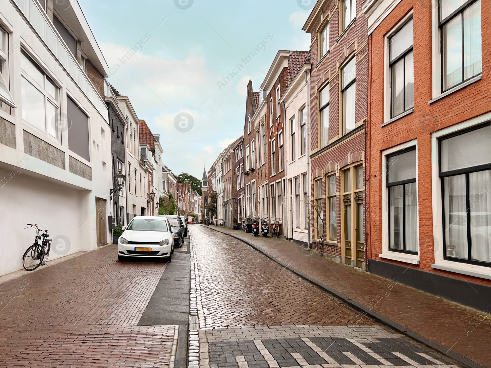 Photo of Picturesque view of city street with beautiful buildings and parked cars