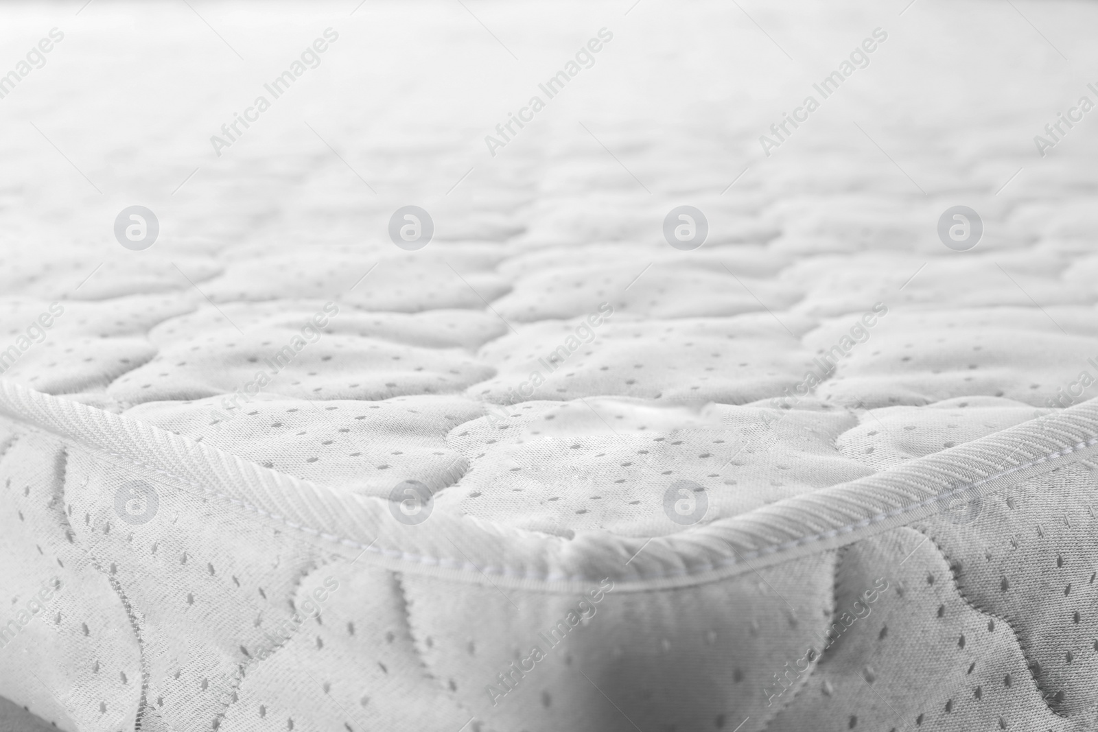 Photo of New light green mattress as background, closeup