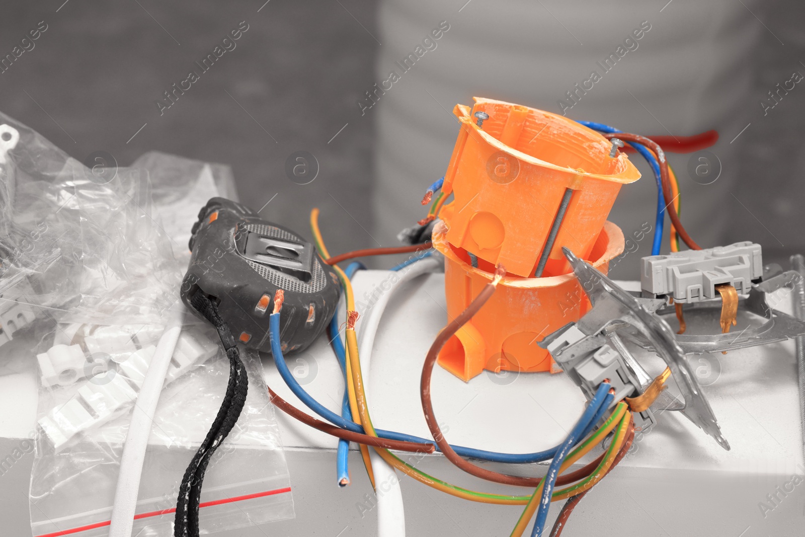 Photo of Mounting boxes, wires and measuring tape indoors, closeup