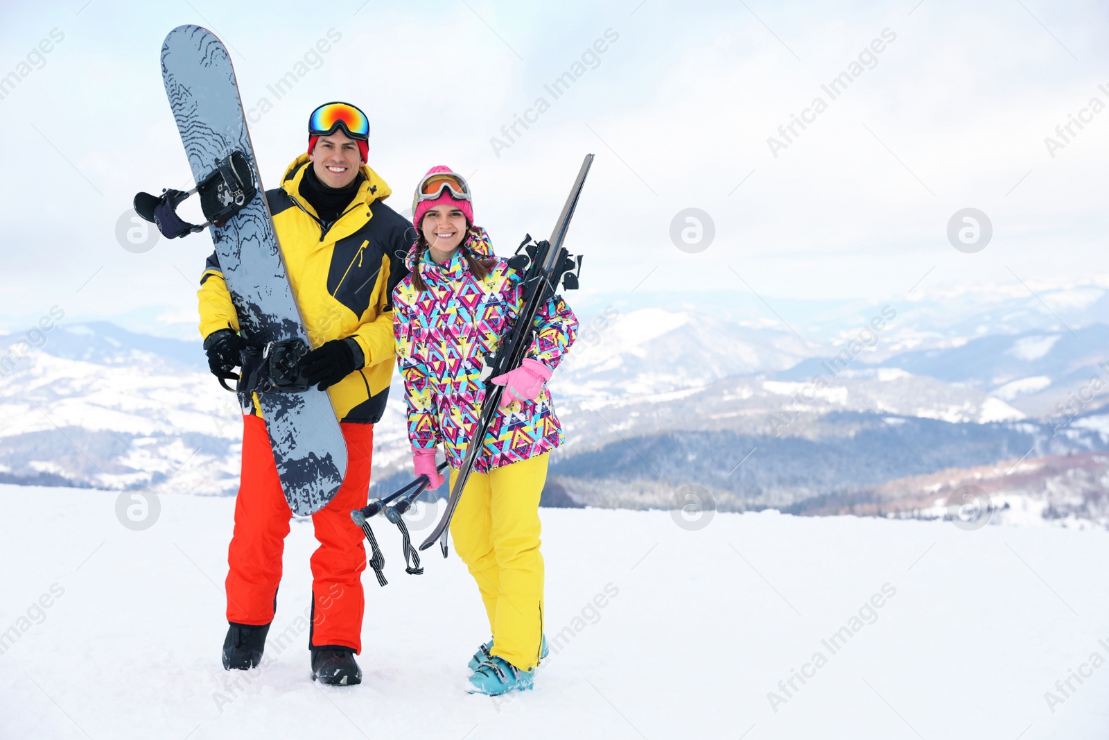 Photo of Lovely couple with equipment at ski resort. Winter vacation