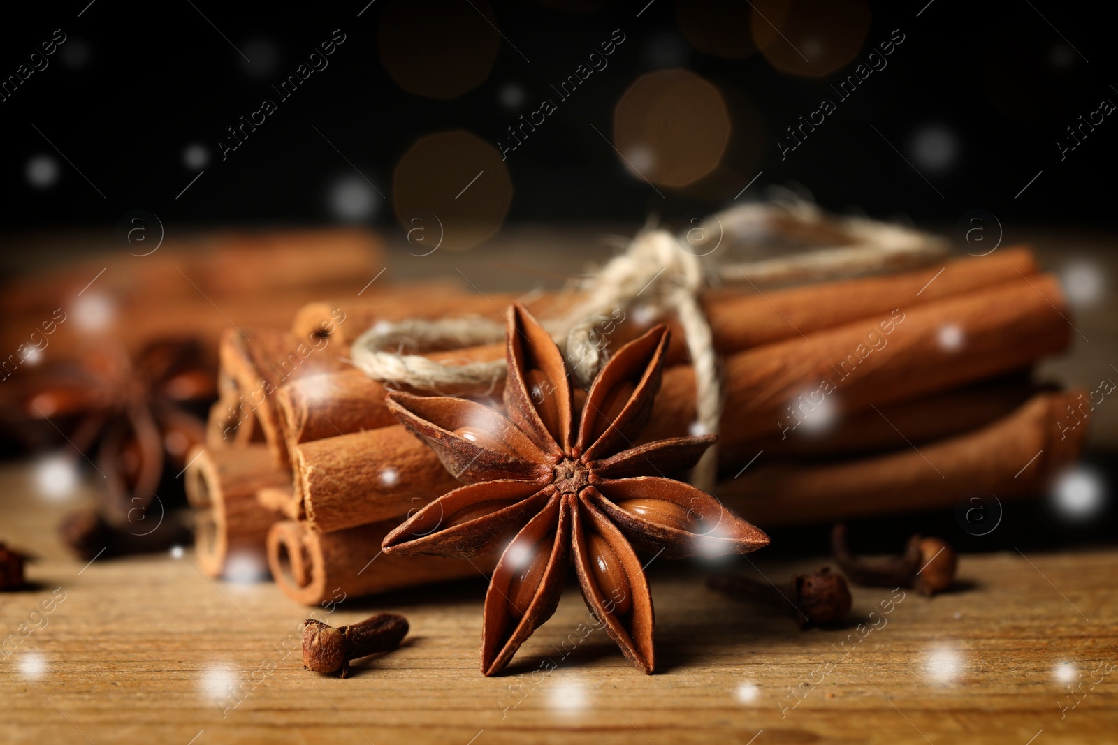 Image of Different spices on wooden table, closeup. Cinnamon, anise, cloves