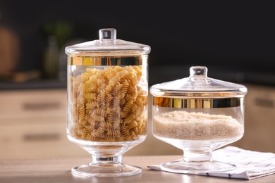 Photo of Raw foodstuff on wooden table in modern kitchen