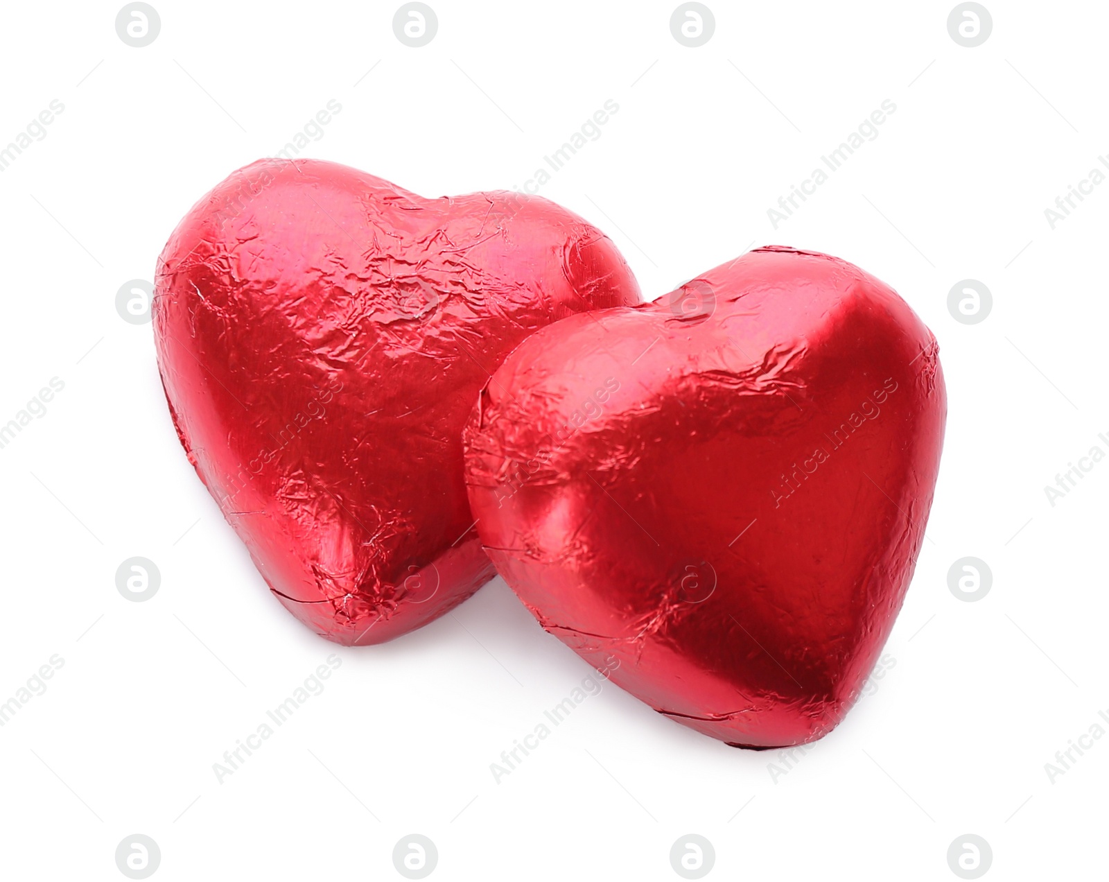 Photo of Heart shaped chocolate candies in red foil on white background, top view