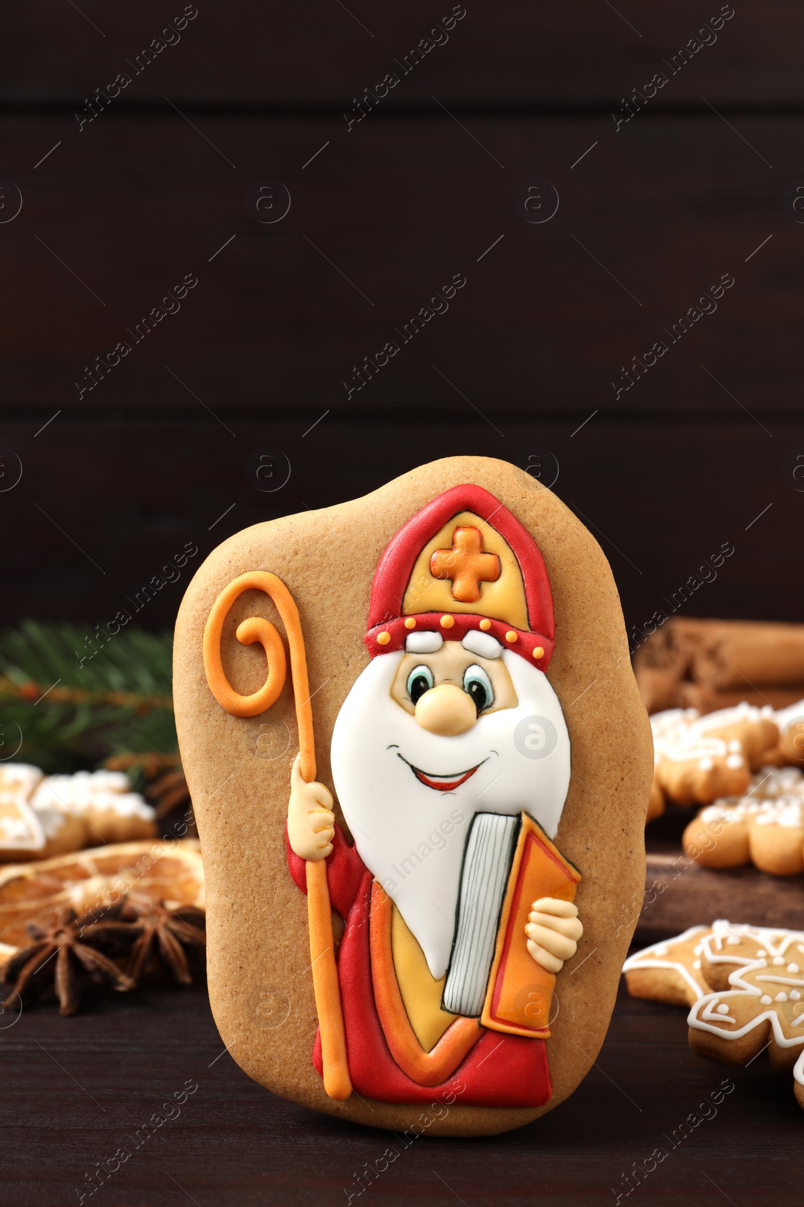Photo of Tasty gingerbread cookies on wooden table. St. Nicholas Day celebration