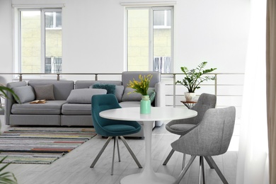 Photo of Modern living room interior with round table and stylish chairs