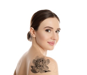 Smiling young woman with beautiful flower tattoo on white background