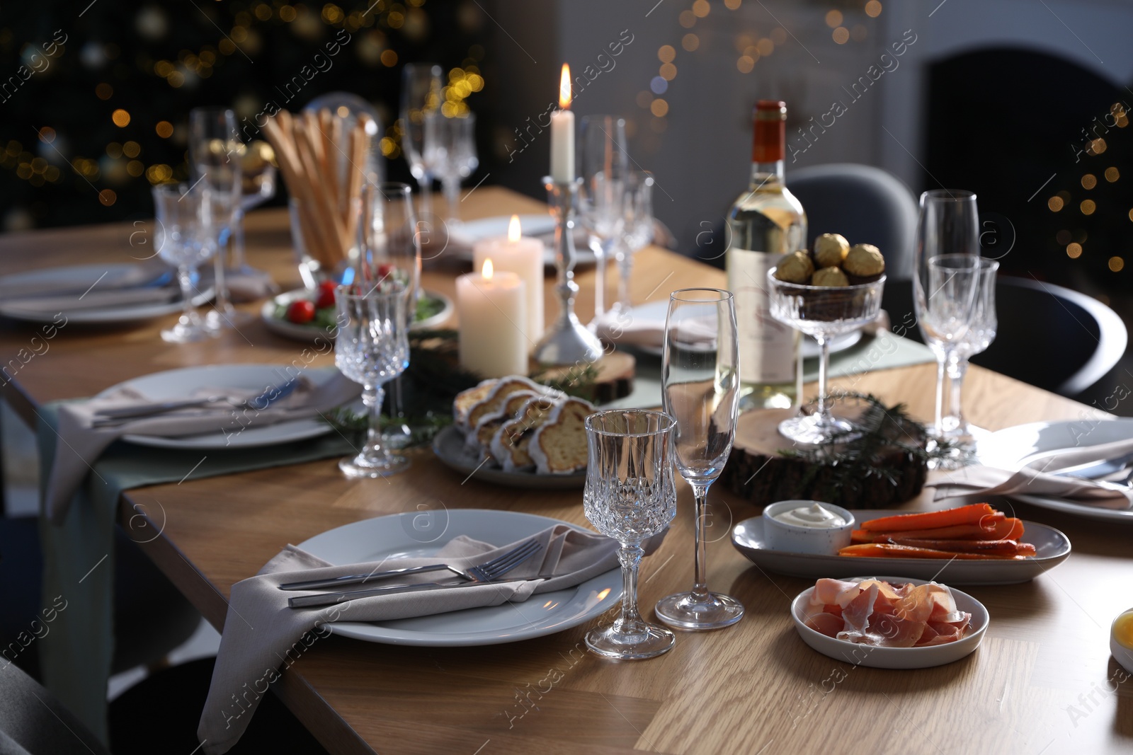 Photo of Christmas table setting with festive decor and dishware indoors