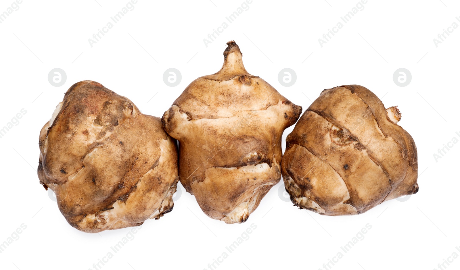 Photo of Jerusalem artichokes isolated on white, top view