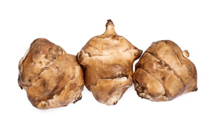 Photo of Jerusalem artichokes isolated on white, top view