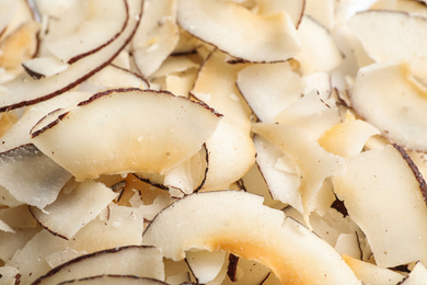 Photo of Delicious fresh coconut chips as background, closeup