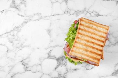 Tasty sandwich with  toasted bread on white marble table, top view. Space for text