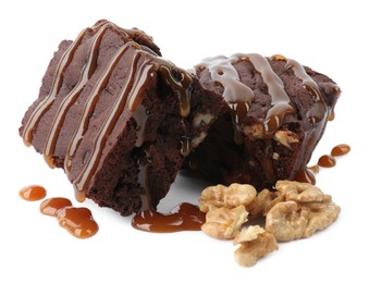 Photo of Delicious chocolate brownies with nuts and caramel sauce on white background