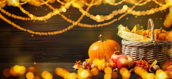 Composition with ripe pumpkins on wooden table, bokeh effect. Happy Thanksgiving day, banner design 