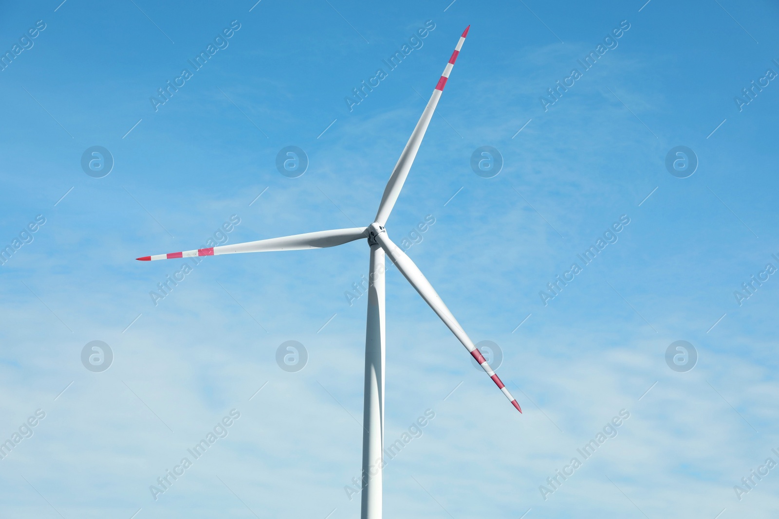 Photo of Modern wind turbine against blue sky. Alternative energy source