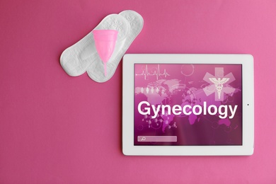 Photo of Flat lay composition with tablet and feminine hygiene items on color background. Gynecological care