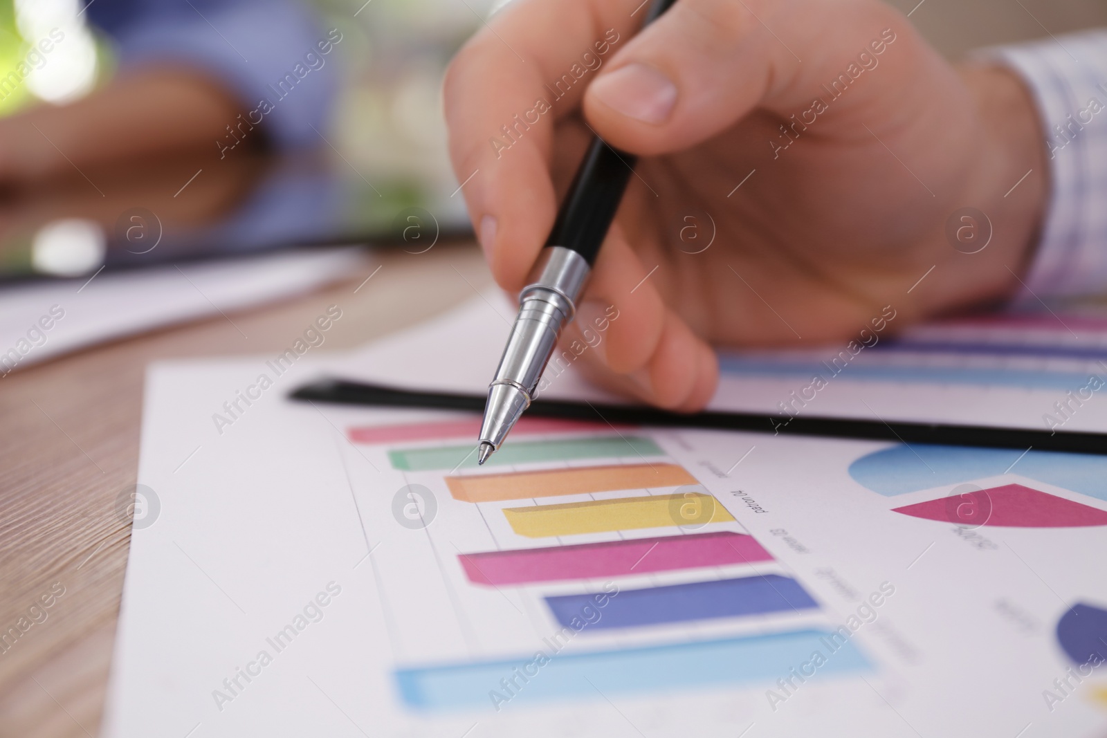 Photo of Business people working with charts and graphs at table in office, closeup. Investment analysis