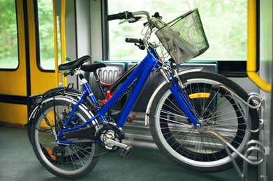 Photo of Different bicycles with big wheels in tram