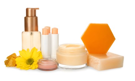 Photo of Natural beeswax and different cosmetic products on white background