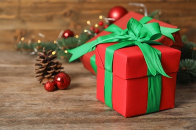 Photo of Red Christmas gift boxes with green bows on wooden table