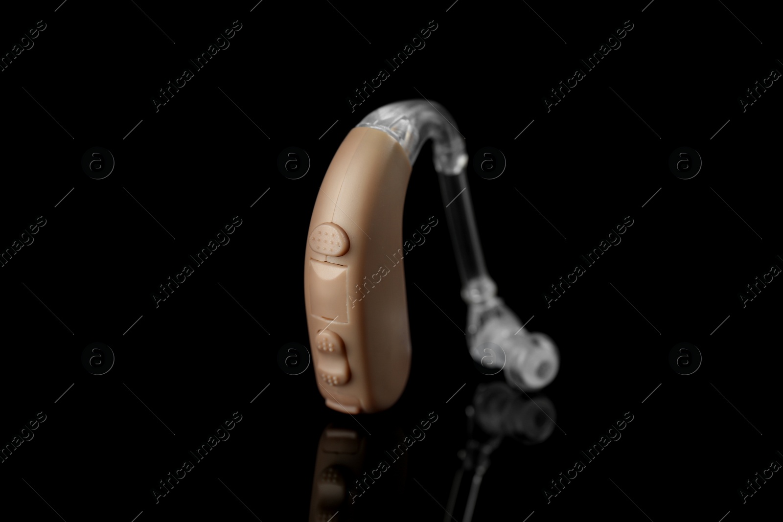 Photo of Hearing aid on black background. Medical device