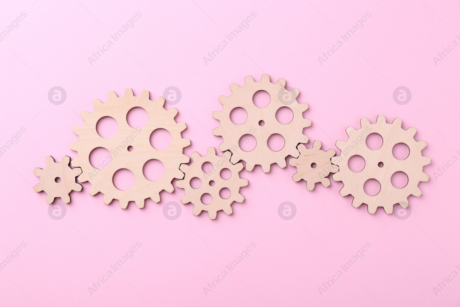 Photo of Business process organization and optimization. Scheme with wooden figures on pink background, top view