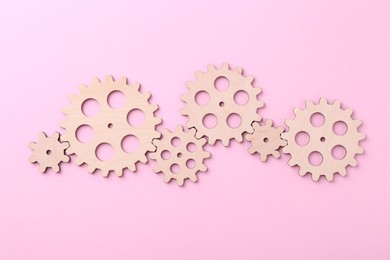 Business process organization and optimization. Scheme with wooden figures on pink background, top view