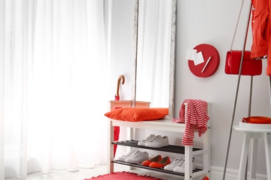 Photo of Cozy stylish hallway interior with shoe rack and mirror, space for text. Home design idea
