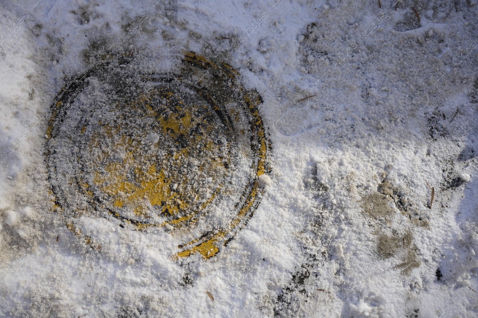 Photo of Sewer hatch covered with snow outdoors, top view