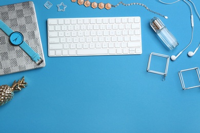 Photo of Blogger's workplace with keyboard and accessories on color background, top view. Space for text