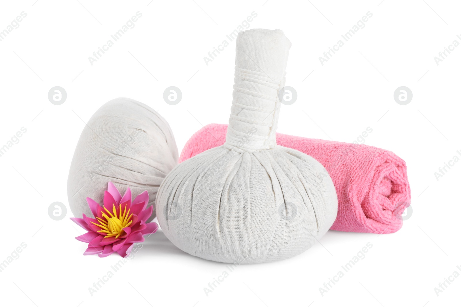 Photo of Herbal massage bags, towel and flower on white background. Spa procedure