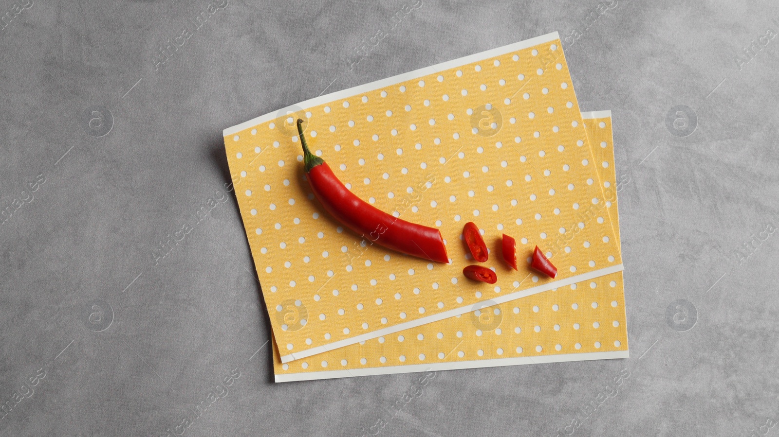 Photo of Pepper plasters and chili on grey textured background, top view