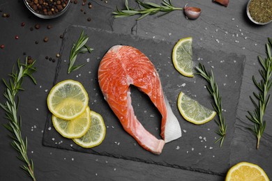 Photo of Tasty salmon steak and different ingredients on grey table, flat lay