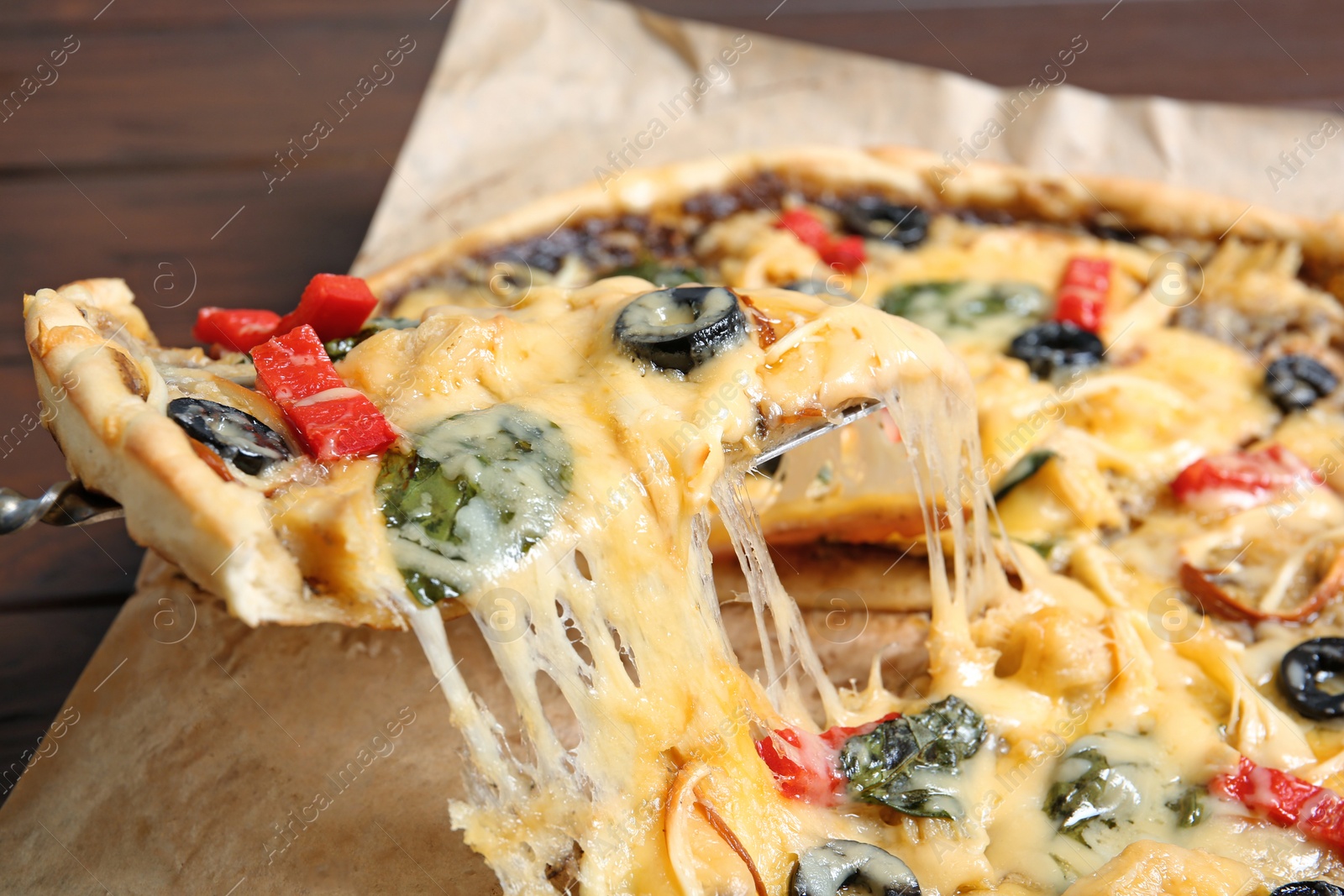 Photo of Taking delicious homemade pizza slice with melted cheese, closeup