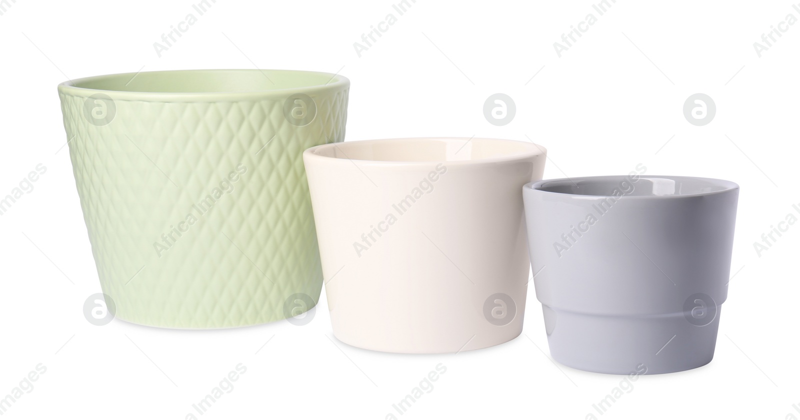 Photo of Different empty ceramic flower pots on white background