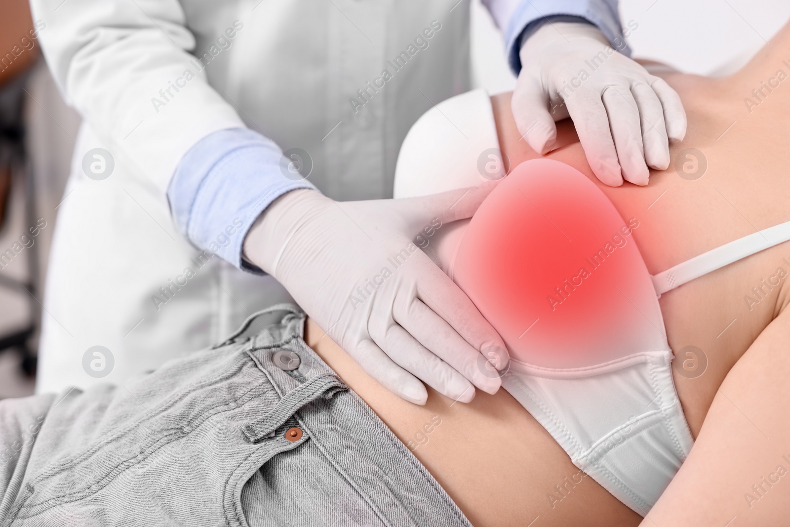 Image of Mammologist checking woman's breast in hospital, closeup