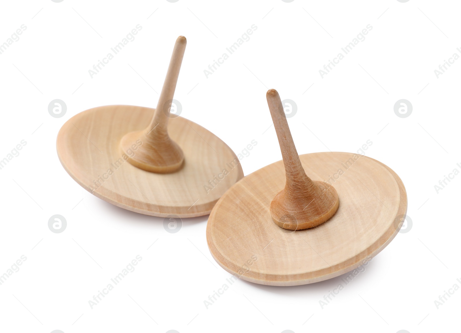 Photo of Two wooden spinning tops isolated on white