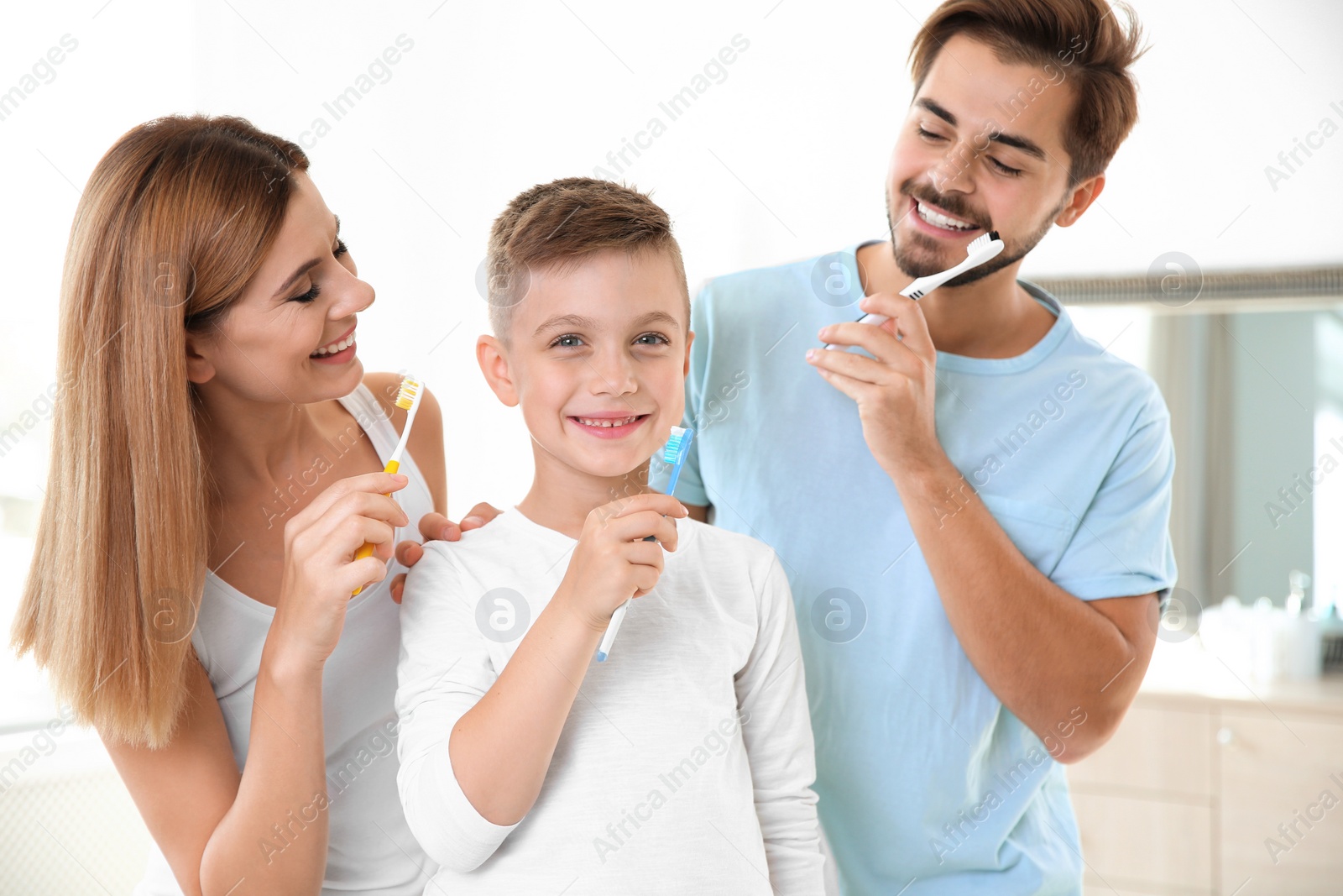 Photo of Happy family with toothbrushes in bathroom. Personal hygiene