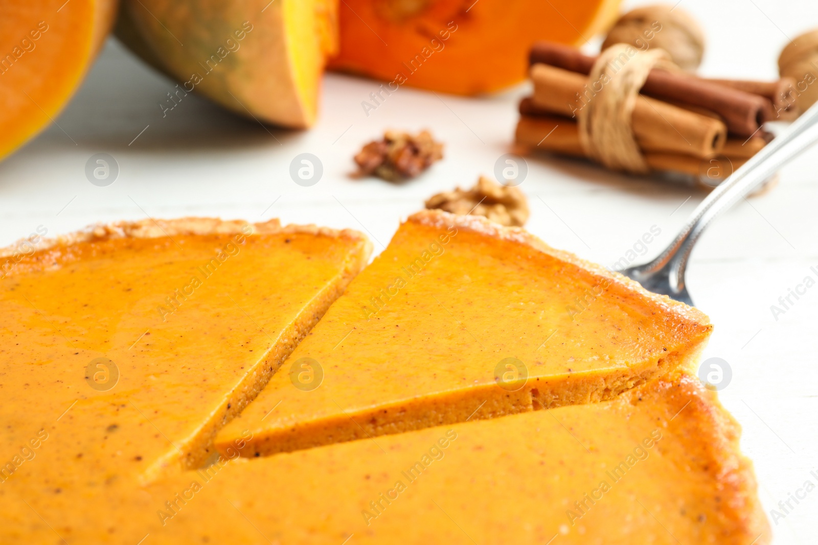 Photo of Delicious fresh homemade pumpkin pie on white table, closeup