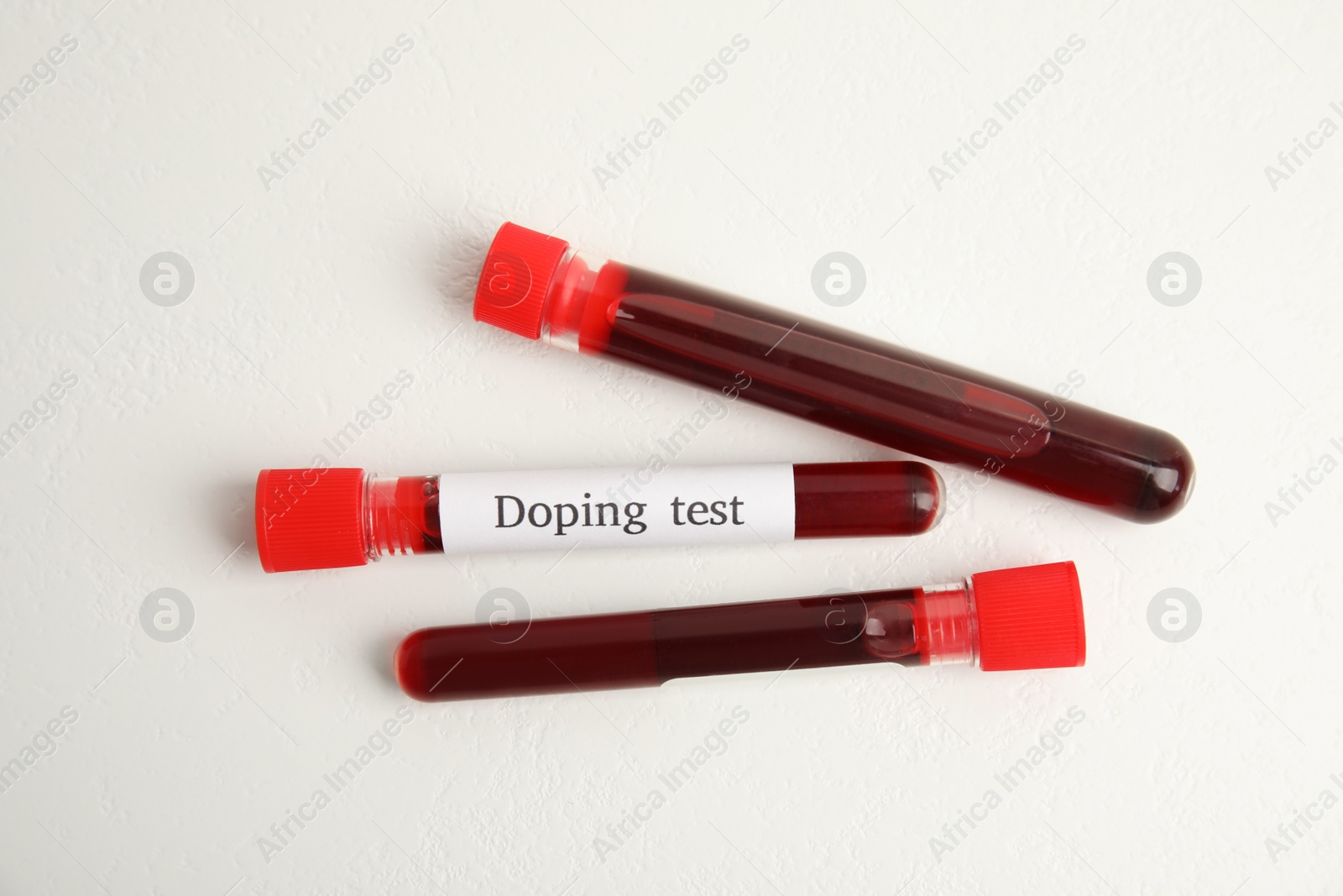 Photo of Test tubes with blood samples on beige background, flat lay. Doping control