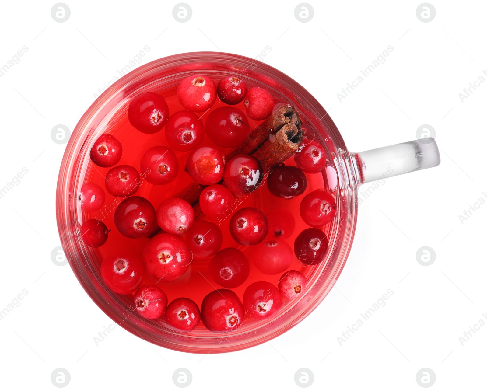 Photo of Tasty hot cranberry tea with cinnamon in glass cup on white background, top view