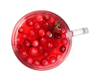 Photo of Tasty hot cranberry tea with cinnamon in glass cup on white background, top view