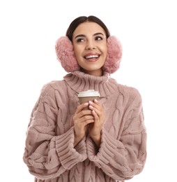 Photo of Beautiful young woman in earmuffs with cup of drink on white background