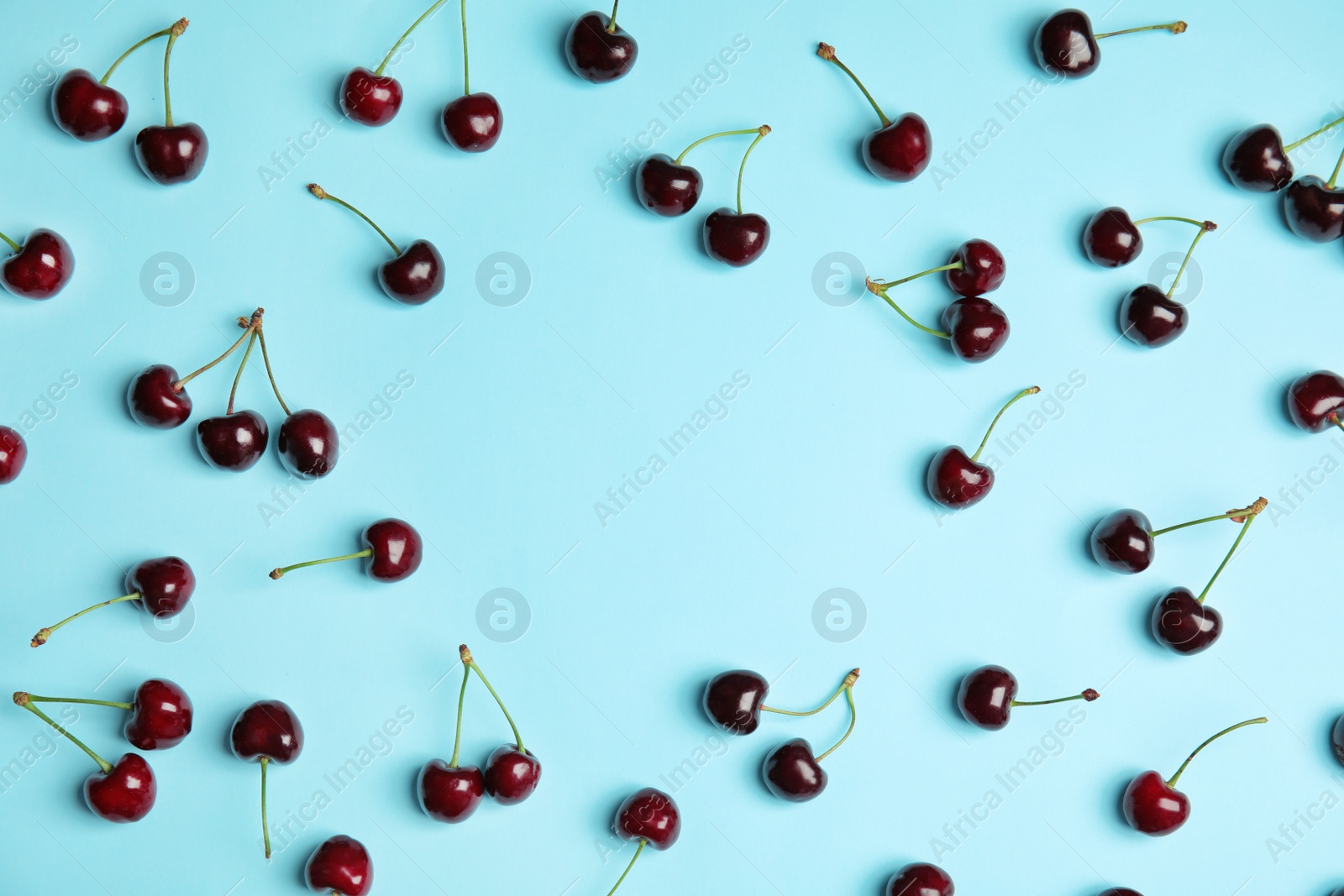 Photo of Flat lay composition with sweet red cherries on color background