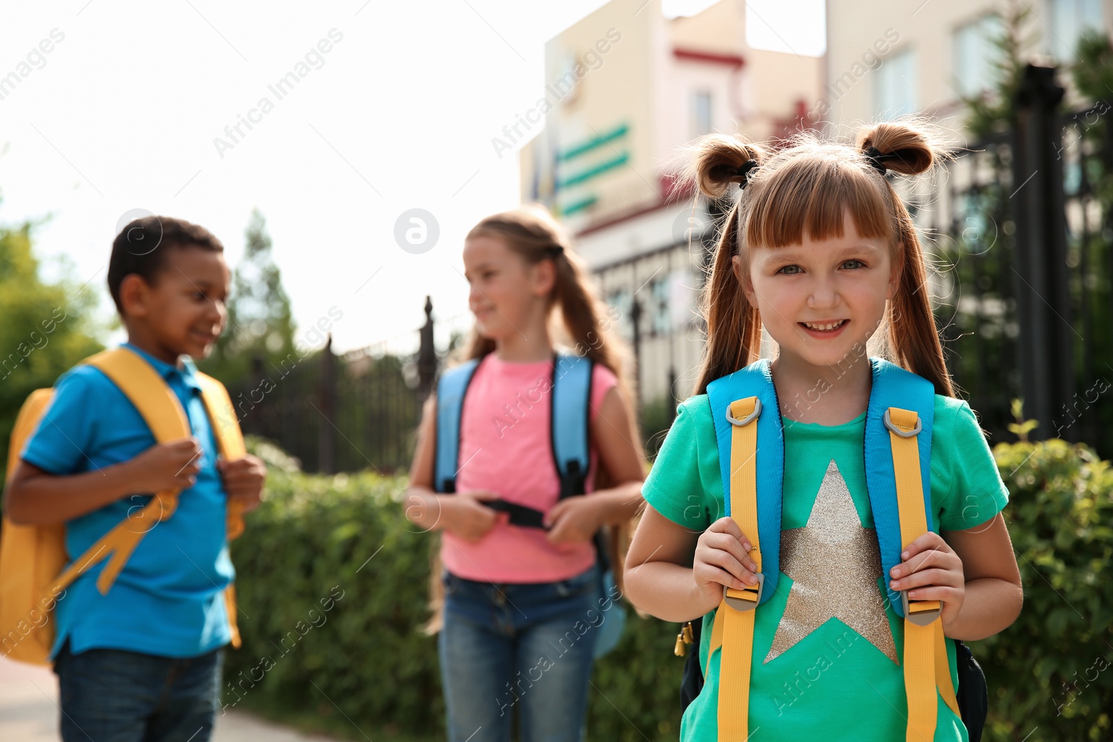 Photo of Cute little child with backpack outdoors. Elementary school