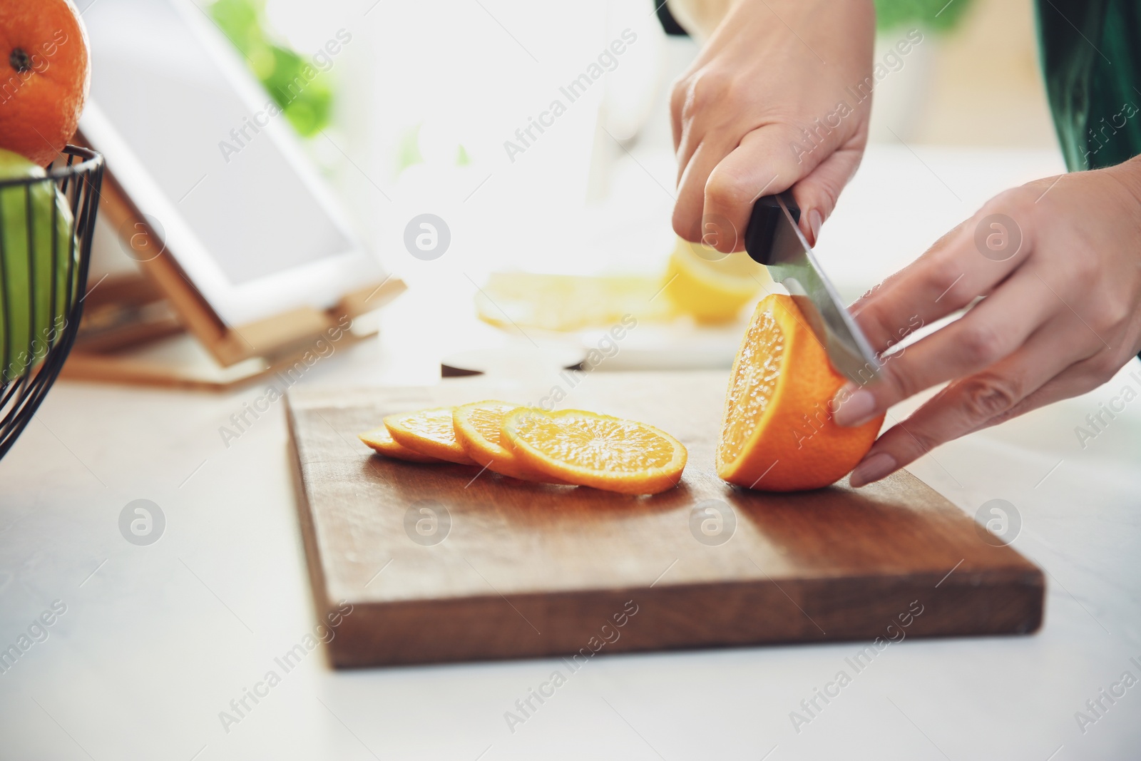 Photo of Woman cooking at table in kitchen, closeup