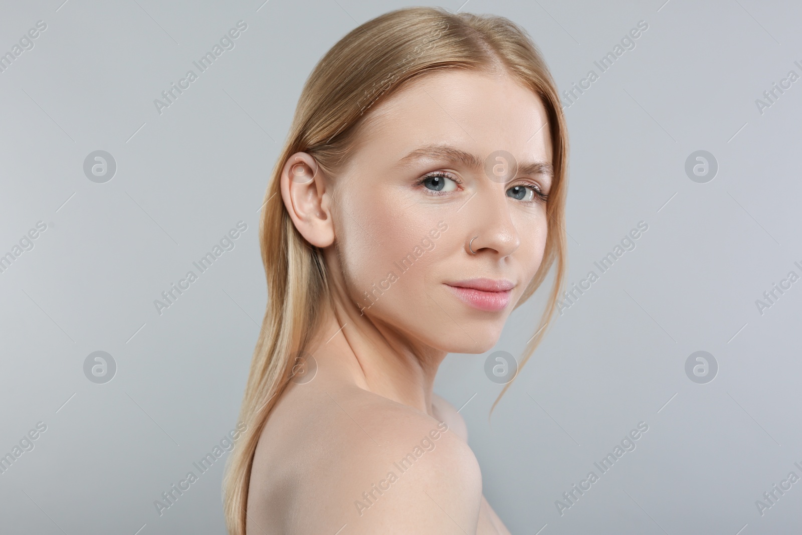 Photo of Portrait of beautiful young woman on grey background