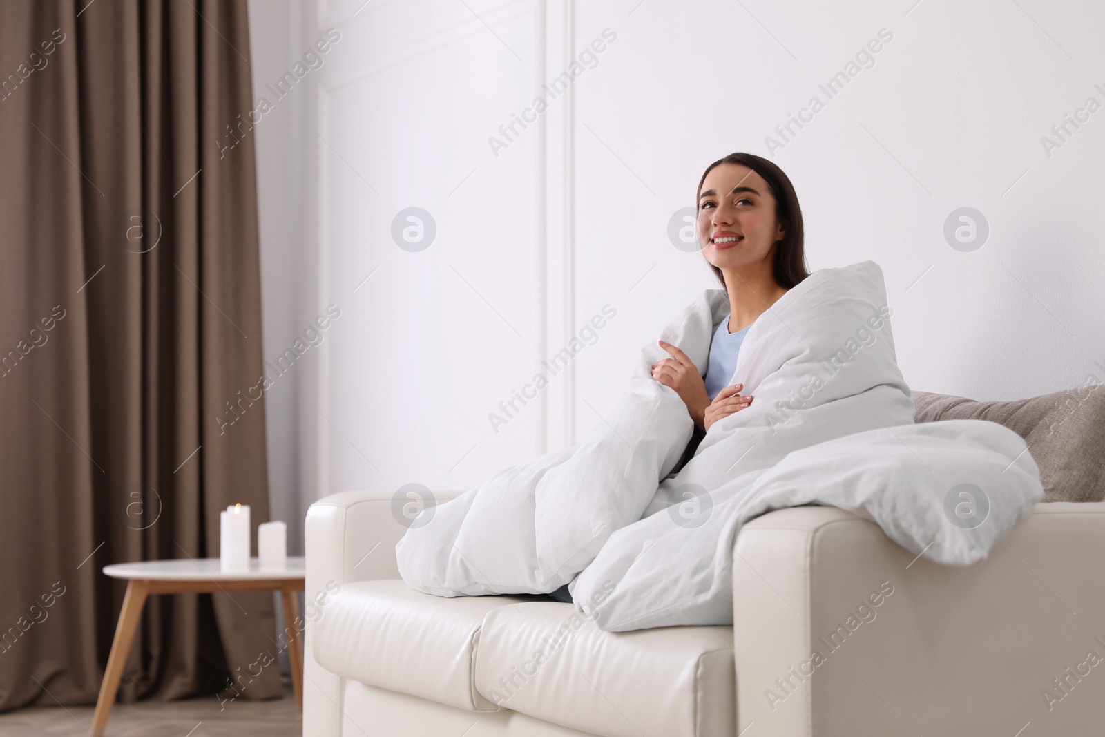 Photo of Woman covered in blanket resting on sofa, space for text