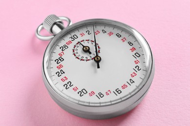 Photo of Vintage timer on pink background. Measuring tool